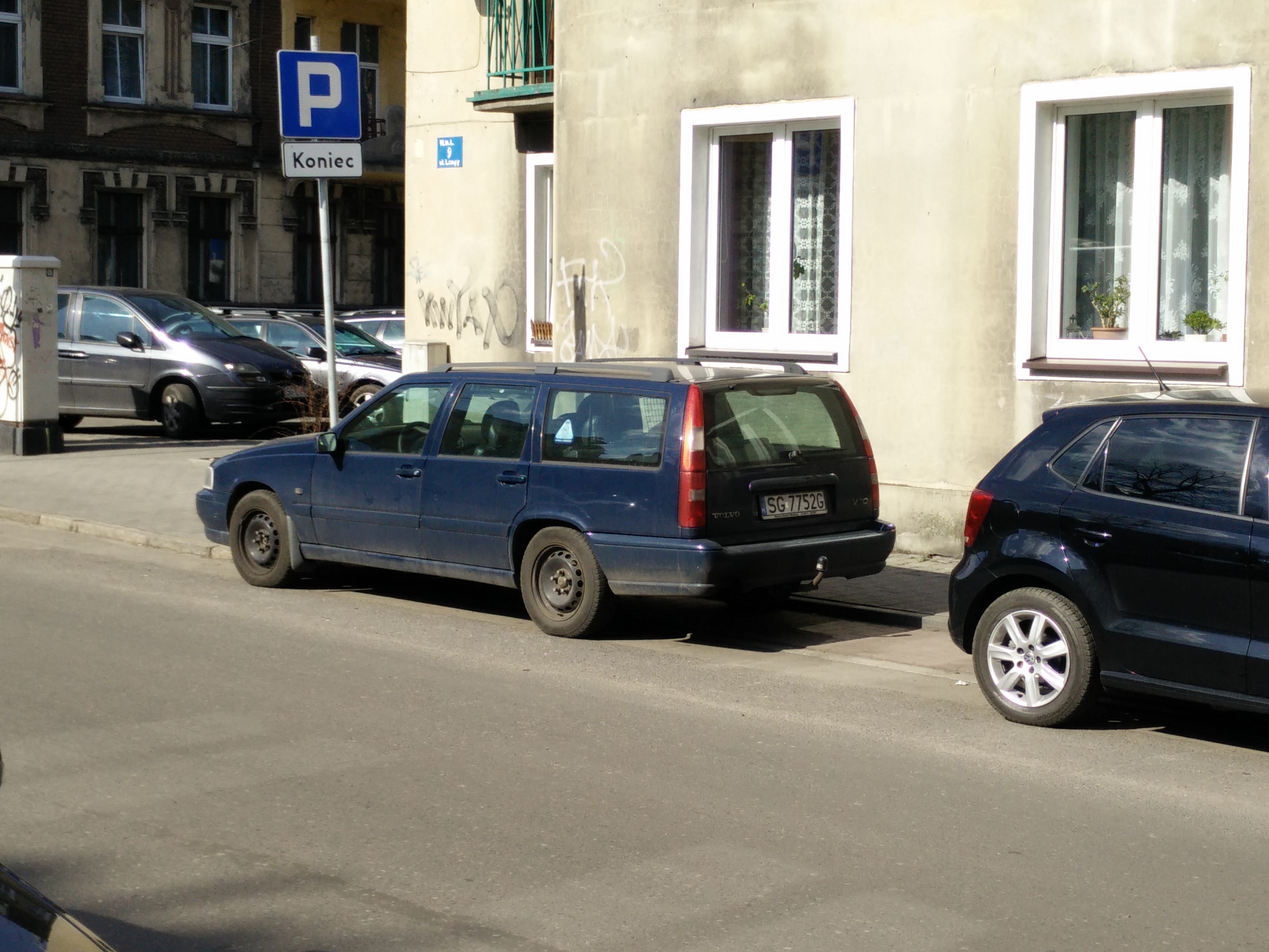 Picture of a car with a parking sign in-frame